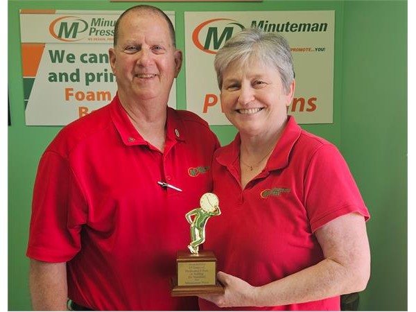 {Minuteman Press Franchise Owners Jeff & Diana Merritt accept their Golden Minuteman Award at their center in Salisbury, MD.}