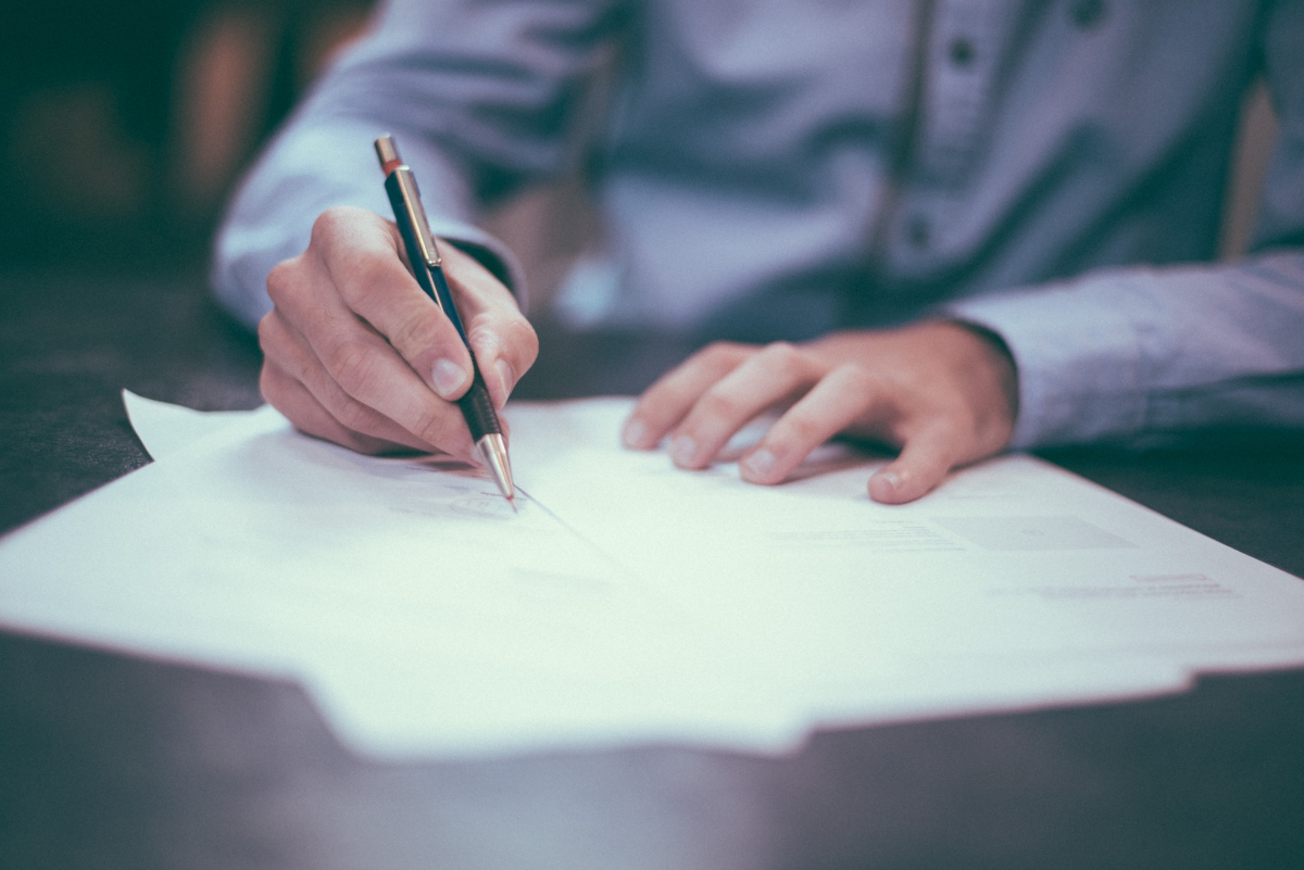 Man signing a sales agreement