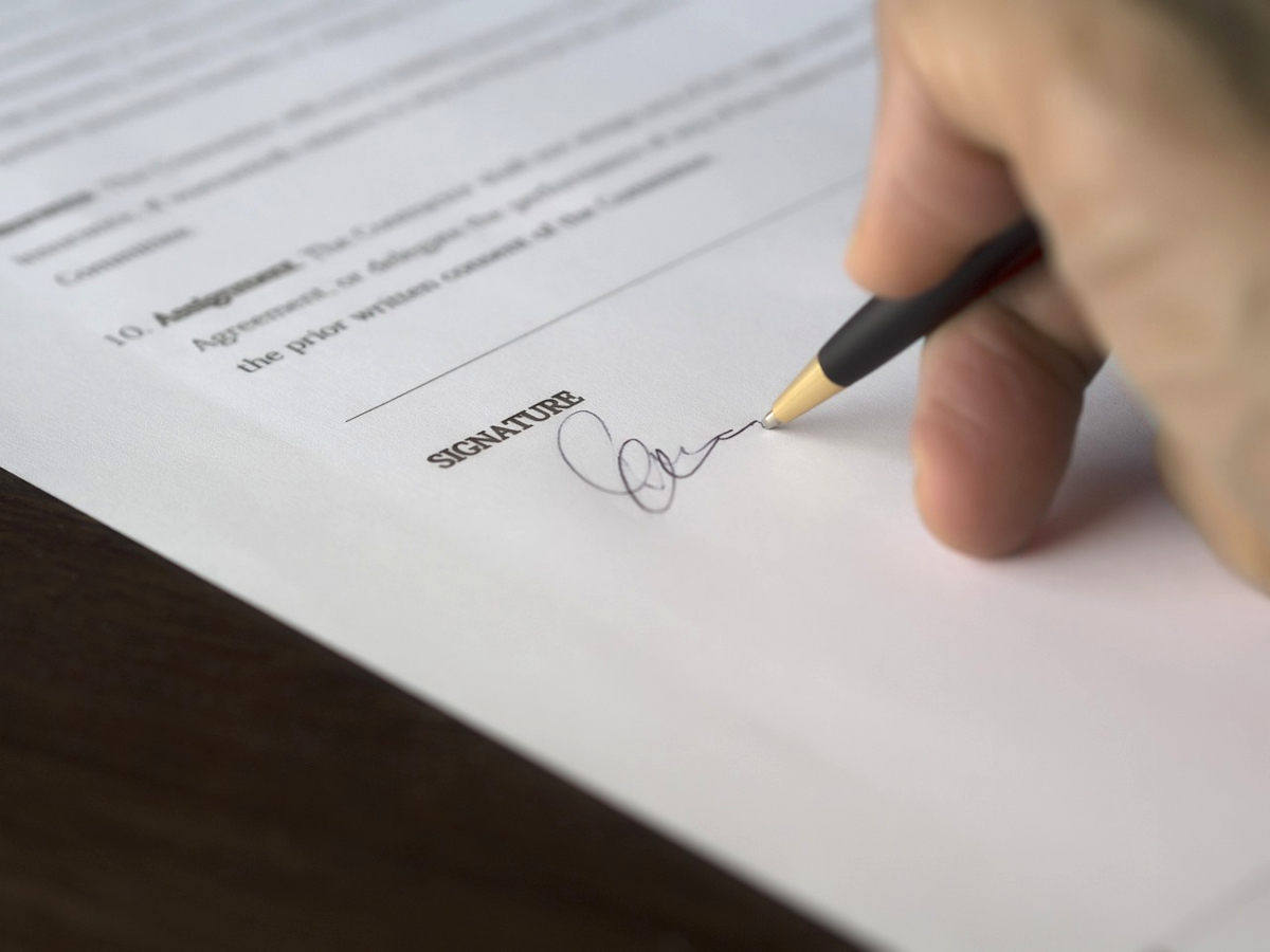 Someone signing a contract