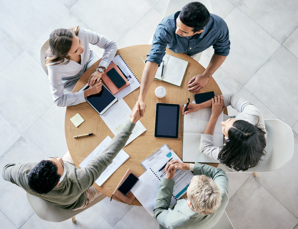 Business people shaking hands at a table