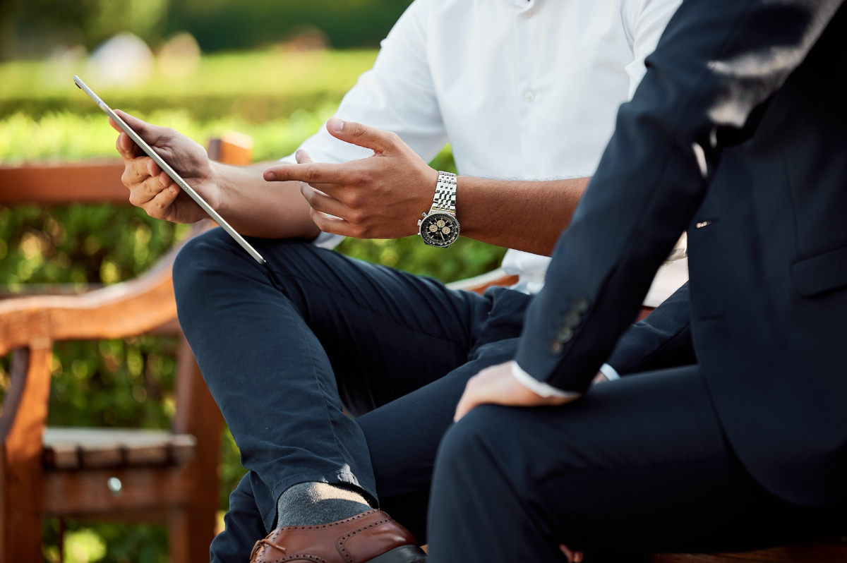 Businessmen sitting outside talking