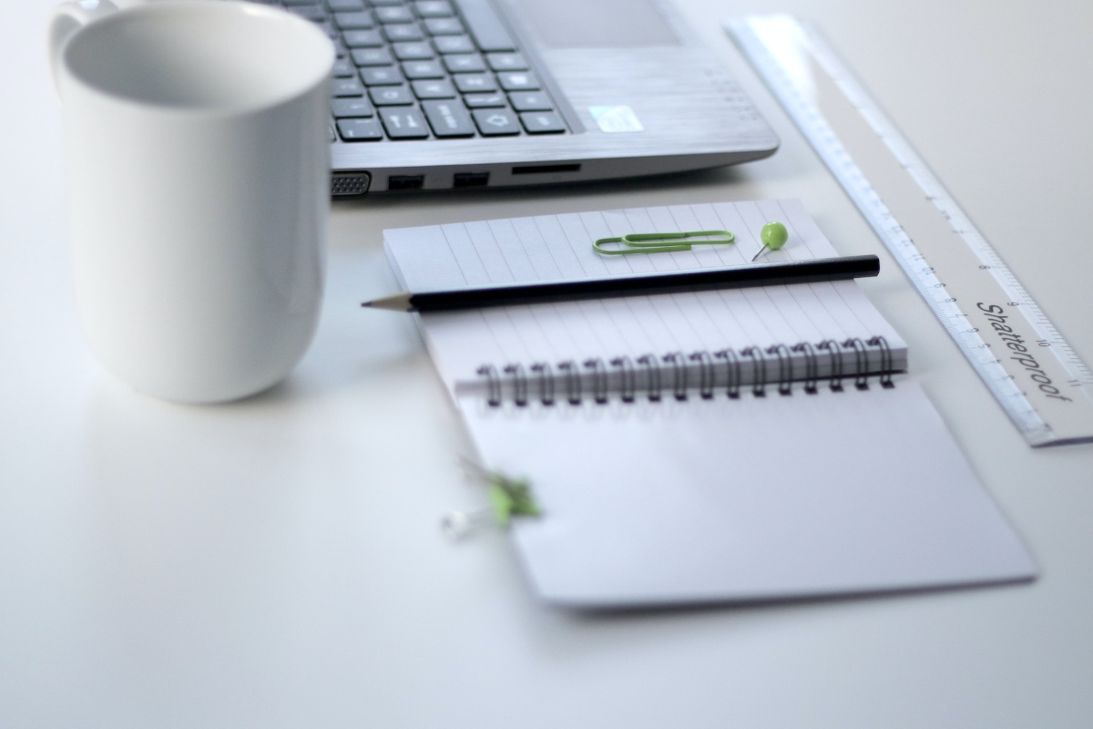 Pen, notebook and laptop on a table