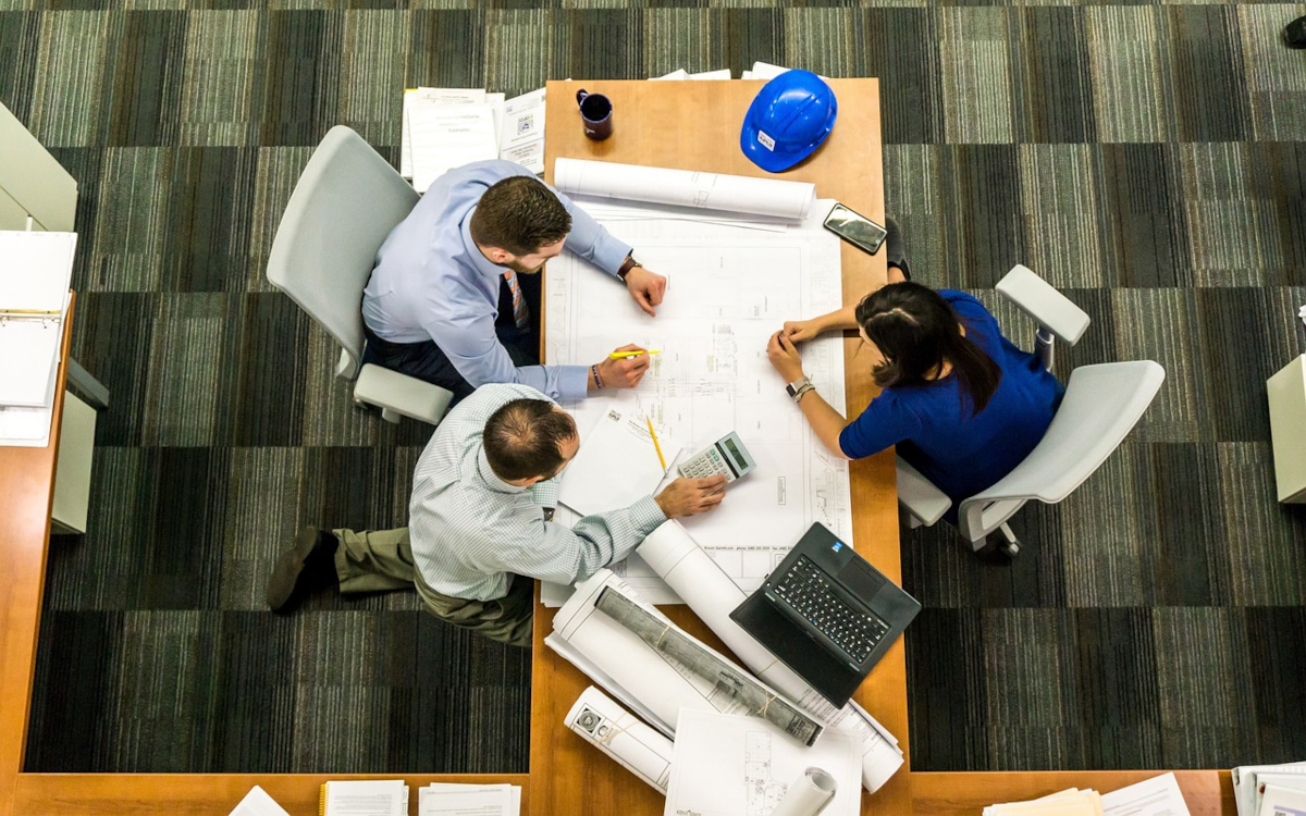 Three business people discussing ideas over a table
