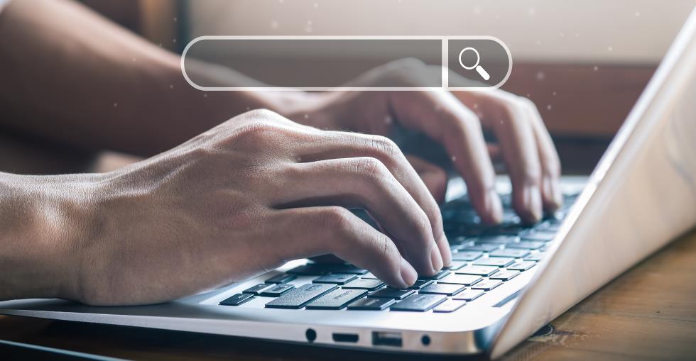 Someone searching on a laptop 