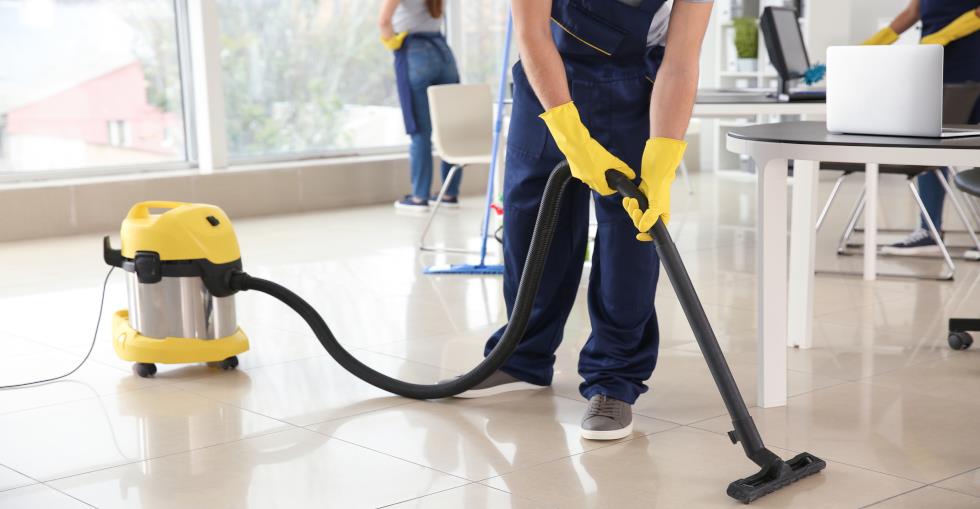 Team of cleaners vacuuming and cleaning windows